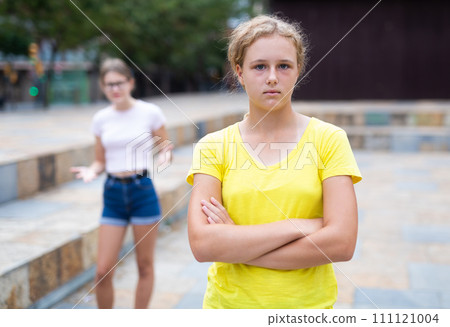 Offended girl turned away from her friend after quarrel on street Offended girl turned away from her friend after quarrel on street 111121004