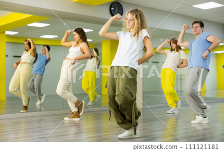 Teenage girl training breakdance Toprock moves in dance hall 111121181