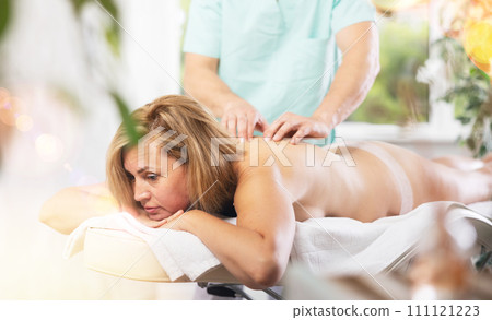 The masseur makes a massage to woman 111121223
