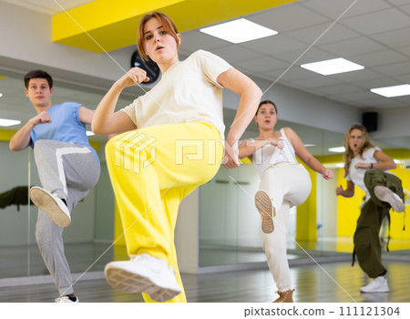 Young girl training breakdance Footwork moves in dance hall 111121304