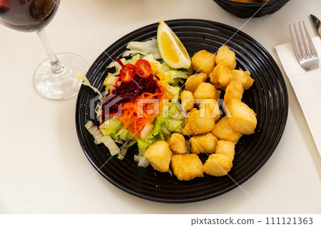 Chopped deep fried sepia with lemon and vegetables 111121363