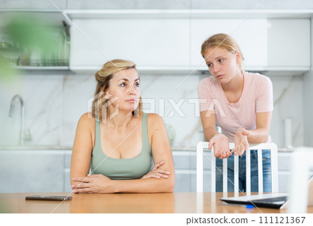Teenage daughter cheers and encourages mother, upset by sudden bad news. Teenage daughter cheers and encourages mother, upset by sudden bad news. 111121367