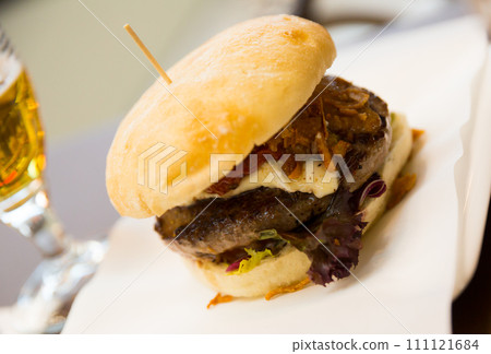 Tasty burger served in cafe Tasty burger served in cafe 111121684