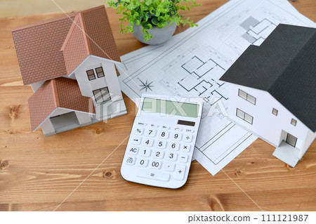 Architectural model of a house, house drawings, and calculator Architectural model of a house, house drawings, and calculator 111121987