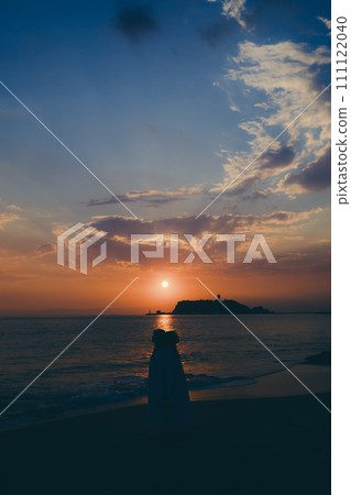 Silhouette of a young woman watching the sunset over a sea of clouds Silhouette of a young woman watching the sunset over a sea of clouds 111122040