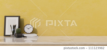 Home decors and a space for displaying your product on a white marble tabletop with the yellow wall. 111123982