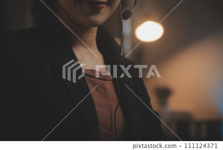 Young woman working in call centre, surrounded by colleagues Young woman working in call centre, surrounded by colleagues 111124371