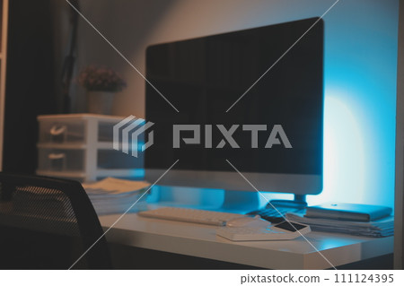 Laptop and paperwork on conference table 111124395