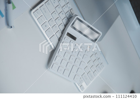 Laptop and paperwork on conference table 111124410