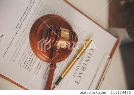 image of judge's hammer, scales lady of justice, law book, laptop computer and contract documents with pen concept of law and justice. 111124436