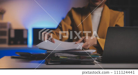 Business woman using calculator for do math finance on wooden desk in office and business working background, tax, accounting, statistics and analytic research concept 111124441