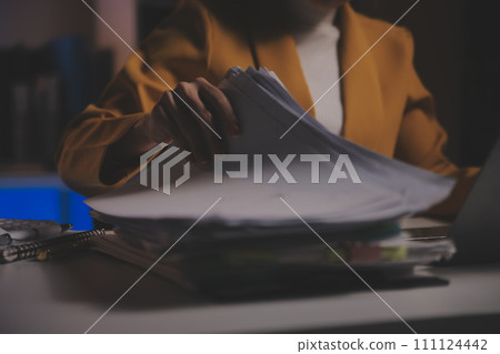 Business woman using calculator for do math finance on wooden desk in office and business working background, tax, accounting, statistics and analytic research concept 111124442