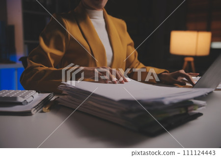 Business woman using calculator for do math finance on wooden desk in office and business working background, tax, accounting, statistics and analytic research concept 111124443