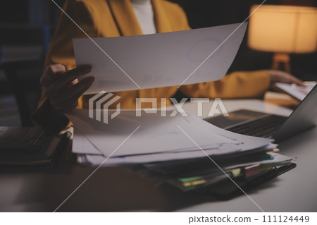 Business woman using calculator for do math finance on wooden desk in office and business working background, tax, accounting, statistics and analytic research concept Business woman using calculator for do math finance on wooden desk in office and business working background, tax, accounting, statistics and analytic research concept 111124449