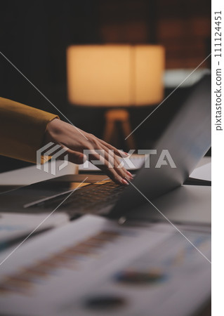 Business woman using calculator for do math finance on wooden desk in office and business working background, tax, accounting, statistics and analytic research concept 111124451