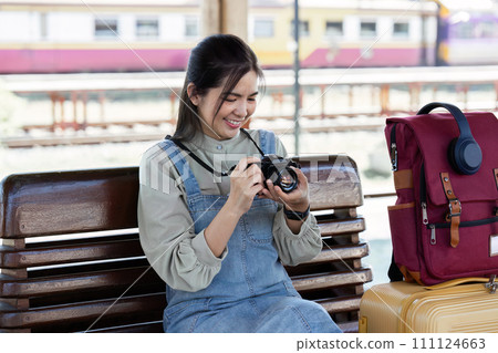 Young Asian woman backpack traveler using a camera. Journey trip lifestyle. travel concept Young Asian woman backpack traveler using a camera. Journey trip lifestyle. travel concept 111124663