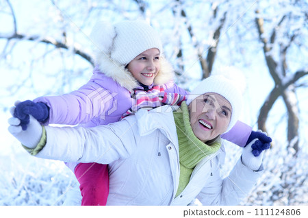 Portrait of grandmother and granddaughter in winter 111124806