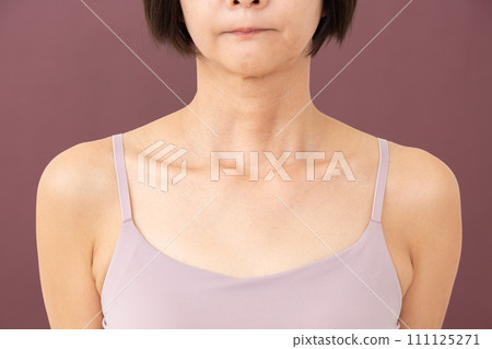 Middle-aged woman's chest and neck 111125271