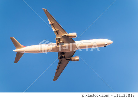 Airplane before landing in blue sky, Airbus A330 111125812