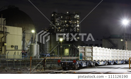 停靠在神奈川臨海鐵道（川崎市）末廣町站貨場的貨運列車的貨櫃和背景中的工廠夜景 111126190