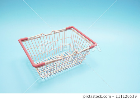 Pink empty shopping basket with space copy on blue background 111126539