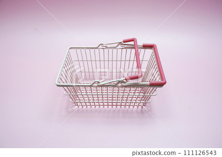 Pink empty shopping basket with space copy on pink background Pink empty shopping basket with space copy on pink background 111126543