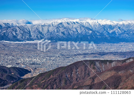 Snow-capped Hotaka Mountain Range in the Northern Alps and the cityscape of Matsumoto City, Nagano Prefecture Snow-capped Hotaka Mountain Range in the Northern Alps and the cityscape of Matsumoto City, Nagano Prefecture 111128063