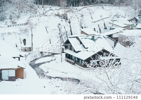 Beautiful view of Ginzan Onsen village with snow fall in winter season is most famous Japanese Hot Spring in Yamagata, Japan. Beautiful view of Ginzan Onsen village with snow fall in winter season is most famous Japanese Hot Spring in Yamagata, Japan. 111129148