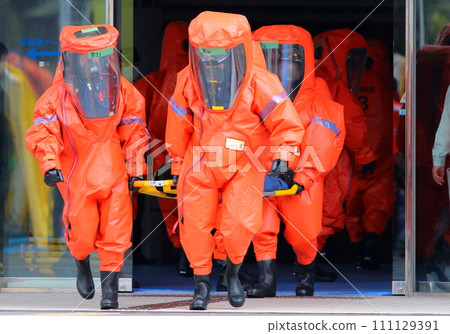 NBC counterterrorism training with citizen participation: Firefighters rescue an injured person on a stretcher 111129391
