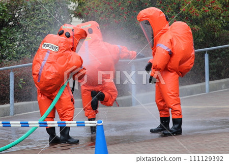 NBC anti-terrorism training with citizen participation: Firefighters spray water on colleagues for decontamination 111129392
