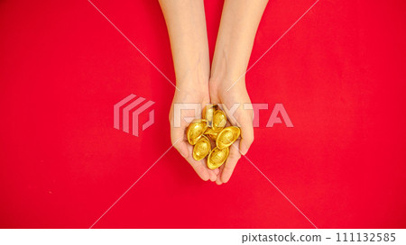 flat lay of hand holding a lot of ancient Chinese ingot gold bar out from the top side for Chinese Lunar New Year celebration background, red theme with copy space flat lay of hand holding a lot of ancient Chinese ingot gold bar out from the top side for Chinese Lunar New Year celebration background, red theme with copy space 111132585