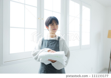 Housewife drying laundry Housewife drying laundry 111133177