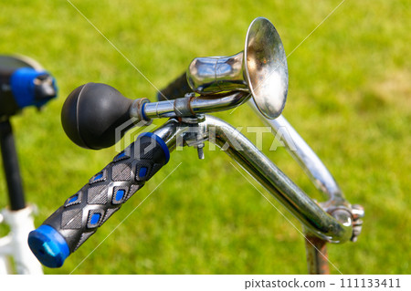 Vintage bicycle horn on handlebar Vintage bicycle horn on handlebar 111133411
