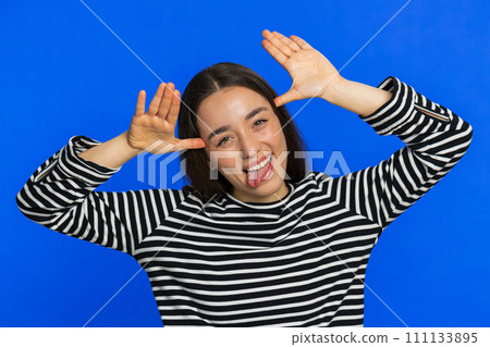 Funny bully Caucasian young woman showing tongue making silly faces, fooling around, joking, teasing Funny bully Caucasian young woman showing tongue making silly faces, fooling around, joking, teasing 111133895