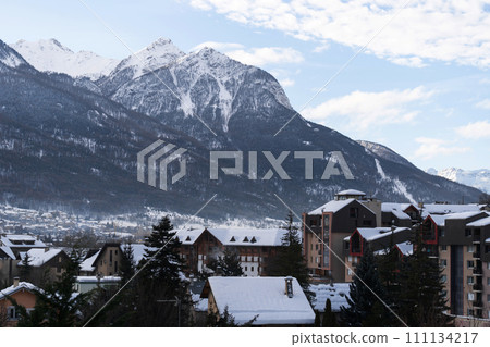 Cityscape of Brianson, ski resort in France. Mountain covered with snow and fog. Alpine landscape 111134217