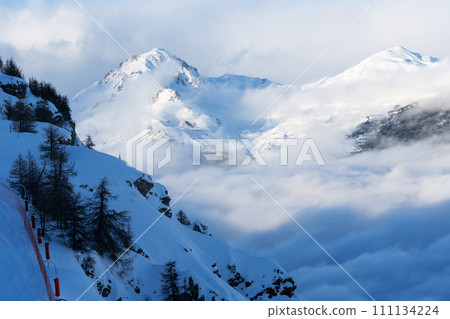Mountain covered with snow and fog. Alpine landscape in Italy, Europe. Snow-capped mountains 111134224