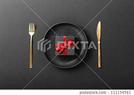 Beautiful romantic table setting on dark background top view Beautiful romantic table setting on dark background top view 111134561
