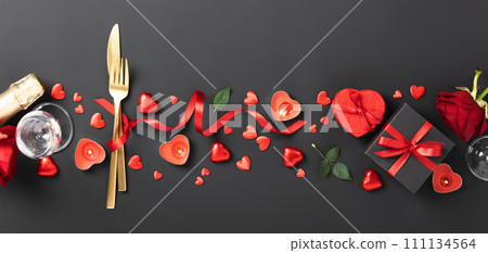 Beautiful romantic table setting on black background. Romantic dinner. Valentine's Day 111134564