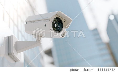 CCTV camera installed on wall of the building. Scan the area for surveillance purposes. Can be used background in security work. 111135212