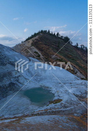 The mountain surface covered with gray-white lava and the desolate hell-like scenery of Kawarage Jigoku in Yuzawa City, Akita Prefecture, Japan 111135213