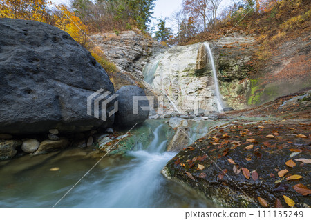 Autumn leaves of Kawarage Jigoku and Kawarage Oyu Falls in Yuzawa City, Akita Prefecture, Japan 111135249