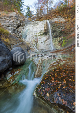 Autumn leaves of Kawarage Jigoku and Kawarage Oyu Falls in Yuzawa City, Akita Prefecture, Japan 111135250