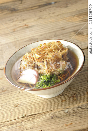 Hot kakiage soba or tempura soba topped with fish cake and green onions Hot kakiage soba or tempura soba topped with fish cake and green onions 111136709