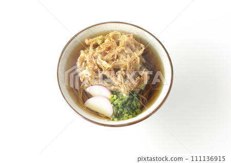 An overhead shot of piping hot kakiage soba or tempura soba topped with fish cake and onions against a white background An overhead shot of piping hot kakiage soba or tempura soba topped with fish cake and onions against a white background 111136915