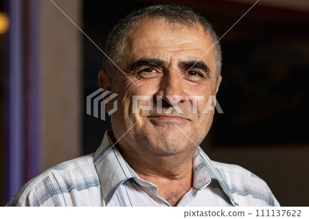 Portrait of a happy 60-year-old Armenian indoors 111137622