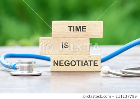 TIME TO NEGOTIATE text on wooden blocks on a green background 111137789