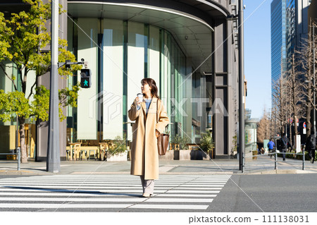 Young woman walking in the office town in winter 111138031