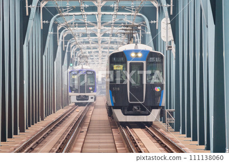[Hanshin Main Line] Local train crossing the Yodogawa Bridge 111138060