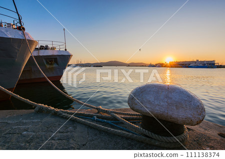 ships moored in harbor at sunset 111138374