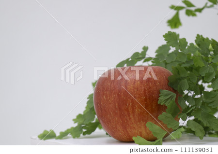 red apple and green leaves 111139031